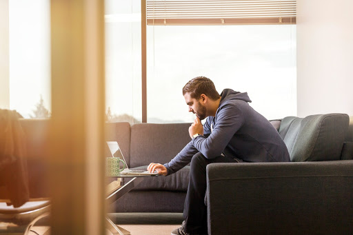 Man sitting on couch ordering prescriptions online