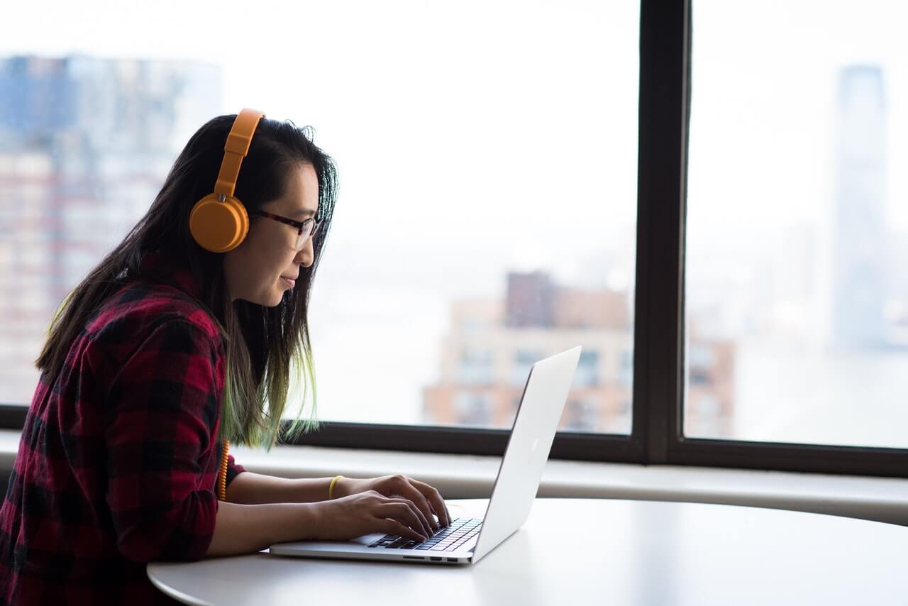 Women on computer with headphones