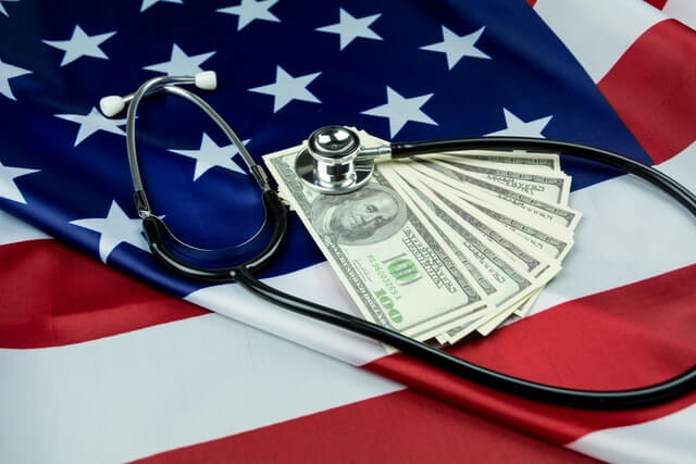 Stethoscope on American currency and flag