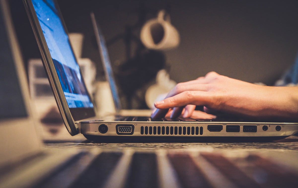 Person on laptop looking up online pharmacy safety tips