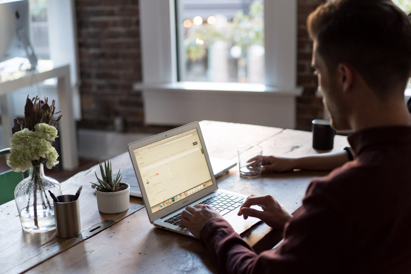 Person with laptop on their desk