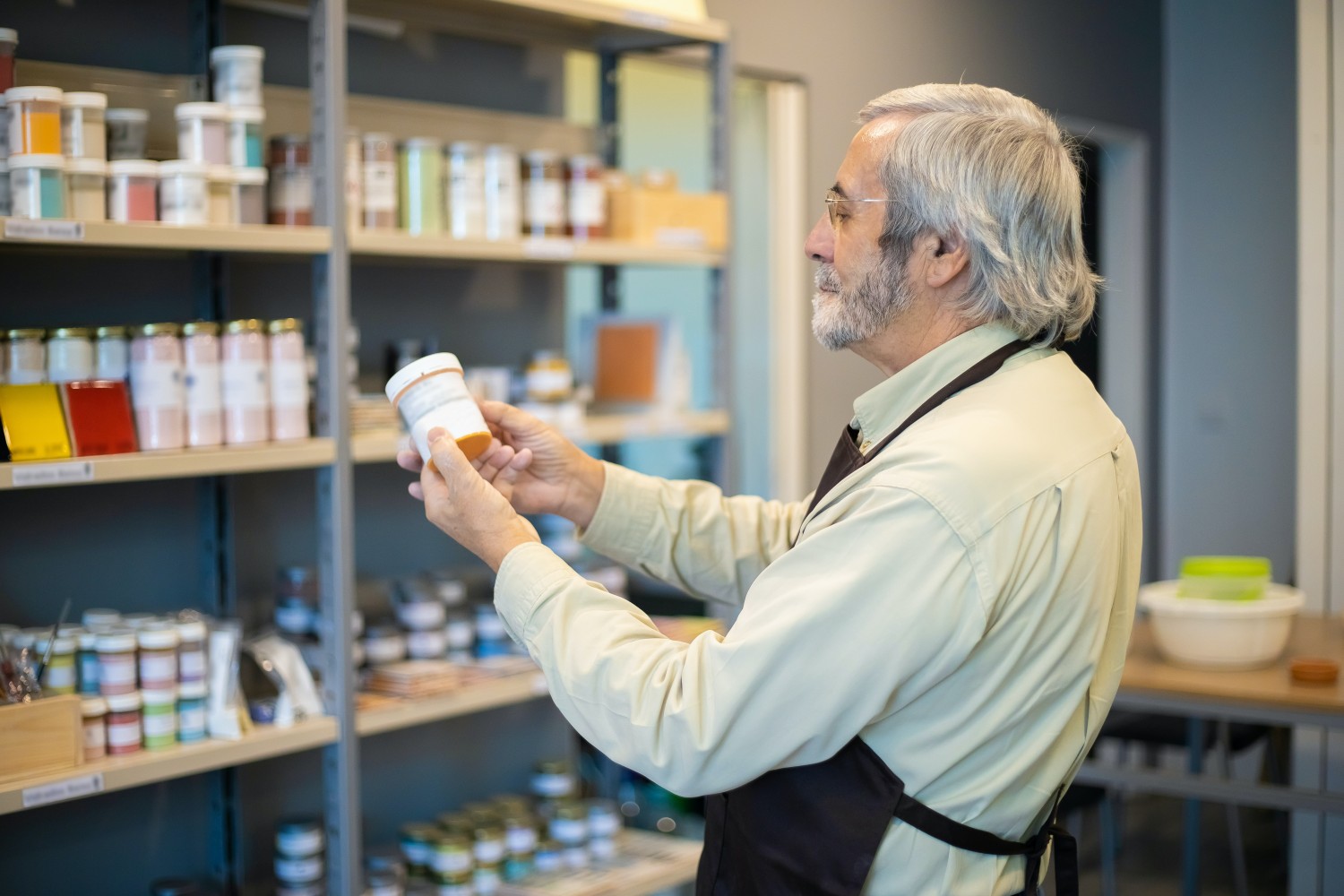 A man holding a white medication bottle