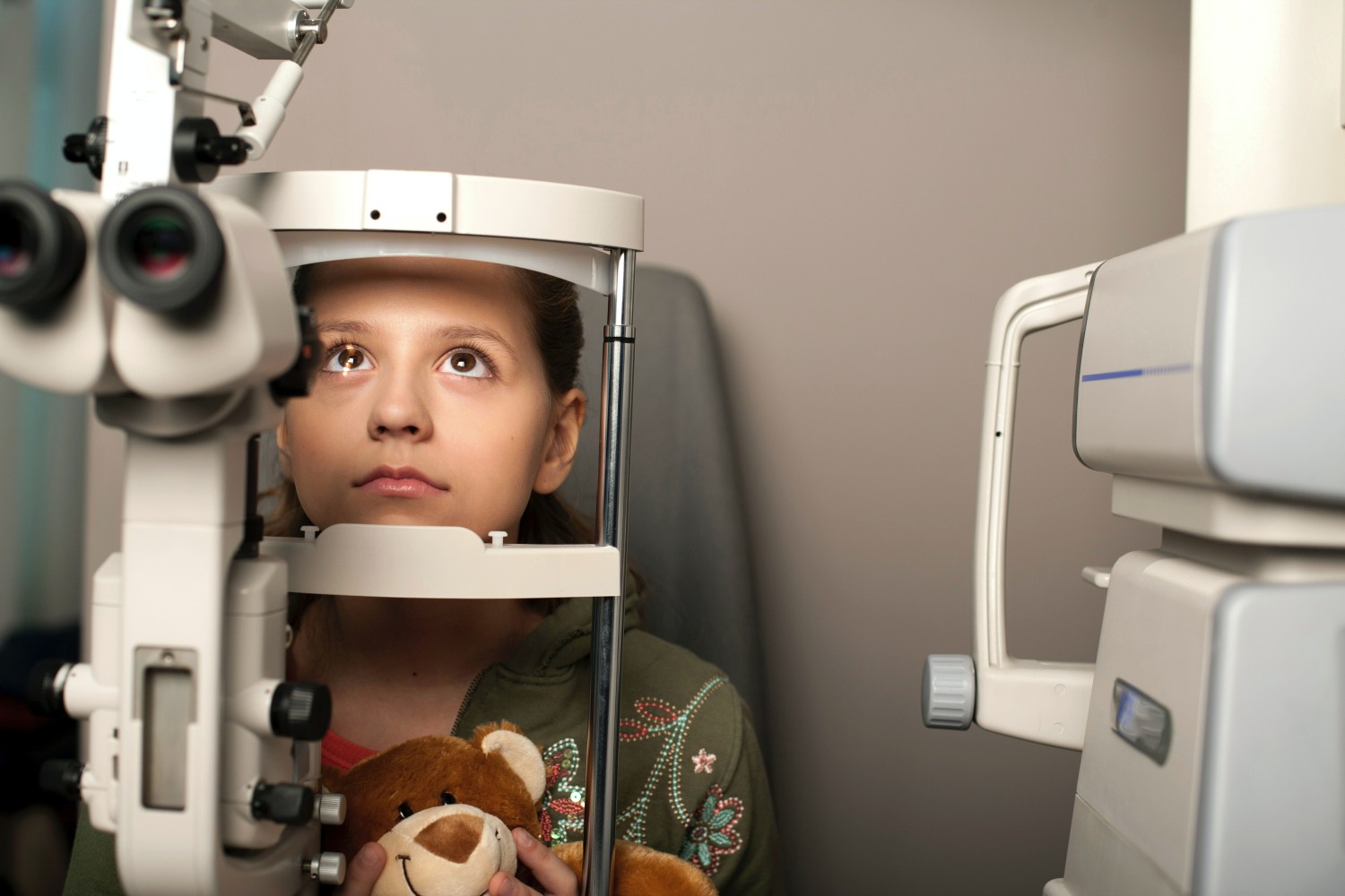 A young girl having her eyes examined